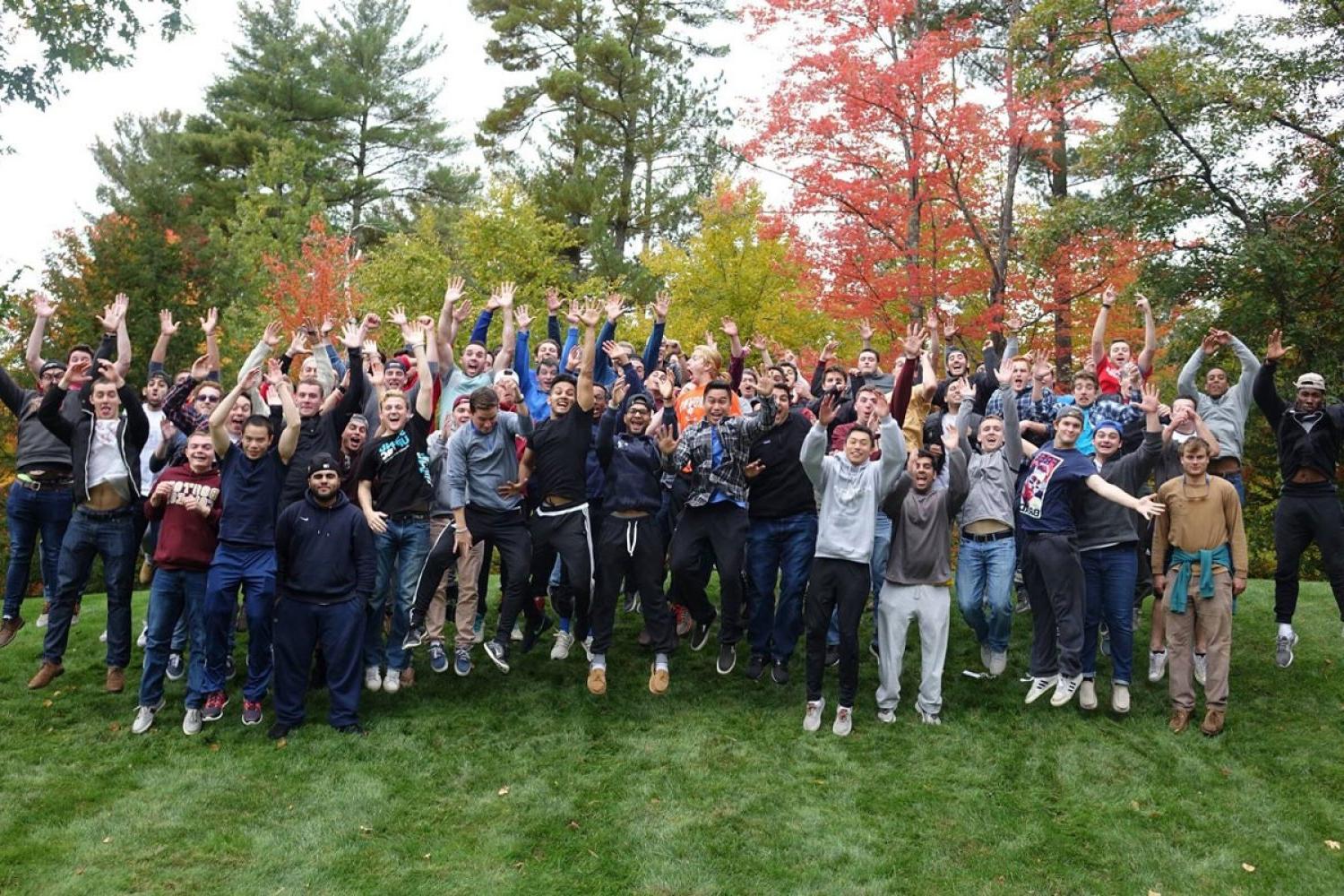 large group of the freshman, juniors and seniors jumping in the air