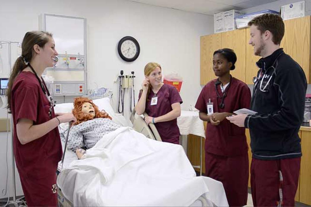 students in scrubs in a hospital setting